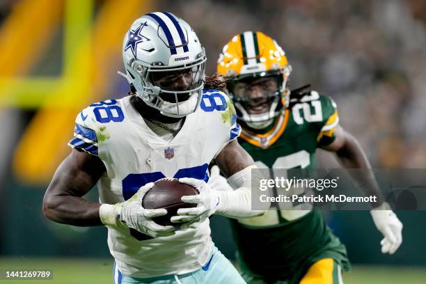 CeeDee Lamb of the Dallas Cowboys runs past Darnell Savage of the Green Bay Packers while scoring a touchdown during the third quarter against the...