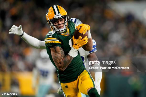 Christian Watson of the Green Bay Packers catches a touchdown pass over DaRon Bland of the Dallas Cowboys during the fourth quarter at Lambeau Field...