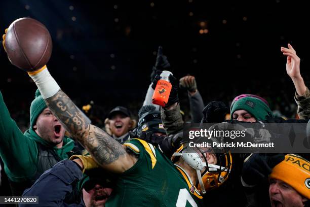 Christian Watson of the Green Bay Packers celebrates with fans after scoring a touchdown during the fourth quarter against the Dallas Cowboys at...