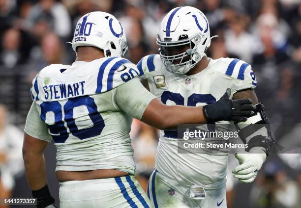 Grover Stewart of the Indianapolis Colts and DeForest Buckner celebrate after a sack on Derek Carr of the Las Vegas Raiders during the fourth quarter...