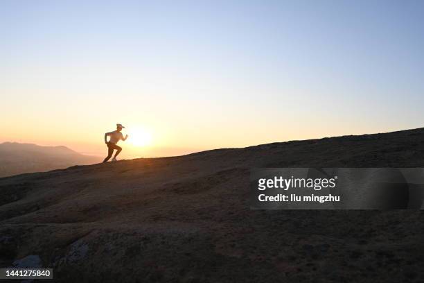 woman running on ridge - china athlete woman stock pictures, royalty-free photos & images