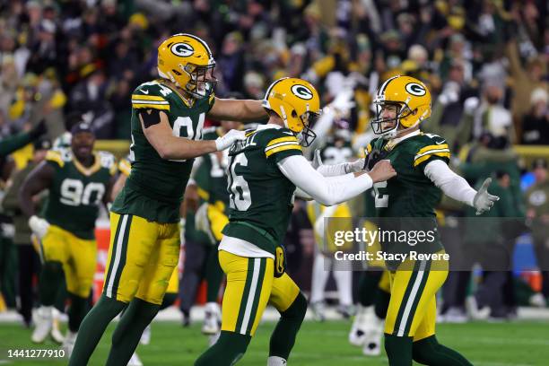 Tyler Davis of the Green Bay Packers and Pat O'Donnell of the Green Bay Packers celebrate with Mason Crosby of the Green Bay Packers after his game...