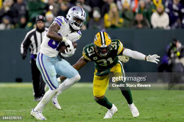 CeeDee Lamb of the Dallas Cowboys catches a pass in front of Adrian Amos of the Green Bay Packers during overtime at Lambeau Field on November 13,...