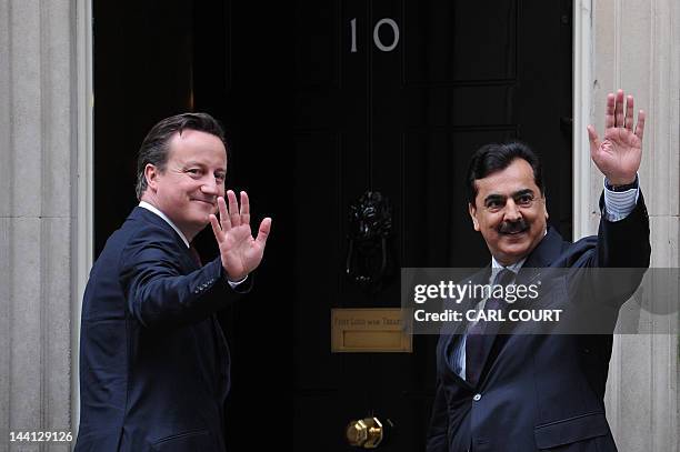 British Prime Minister David Cameron and Pakistan's Prime Minister Yousuf Raza Gilani wave to the media after a meeting in 10 Downing Street, London,...