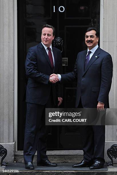 British Prime Minister David Cameron and Pakistan's Prime Minister Yousuf Raza Gilani pose for pictures after a meeting at 10 Downing Street, London,...