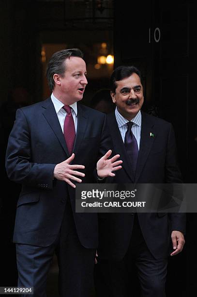 British Prime Minister David Cameron and Pakistan's Prime Minister Yousuf Raza Gilani prepare to pose for pictures after a meeting at 10 Downing...
