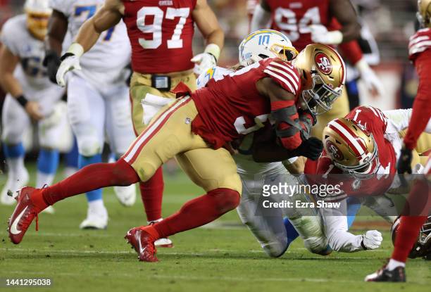 Dre Greenlaw of the San Francisco 49ers hits Justin Herbert of the Los Angeles Chargers during the second quarter at Levi's Stadium on November 13,...