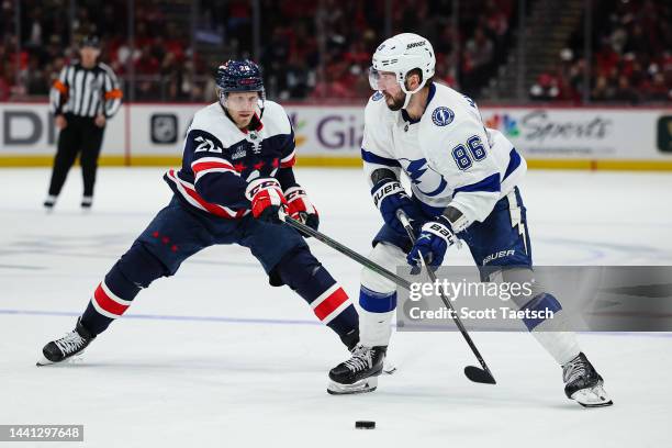 Nikita Kucherov of the Tampa Bay Lightning skates with the puck as Garnet Hathaway of the Washington Capitals defends during the third period of the...