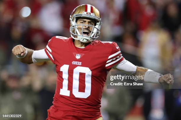Jimmy Garoppolo of the San Francisco 49ers celebrates after a touchdown by Christian McCaffrey during the fourth quarter against the Los Angeles...