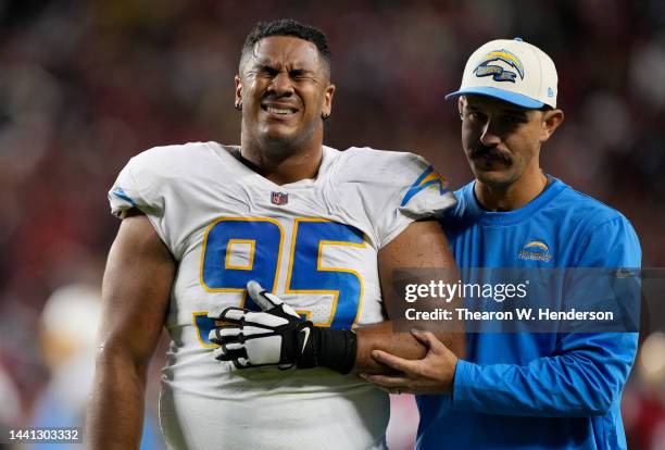 Christian Covington of the Los Angeles Chargers is helped off the field after suffering an injury during the fourth quarter against the San Francisco...