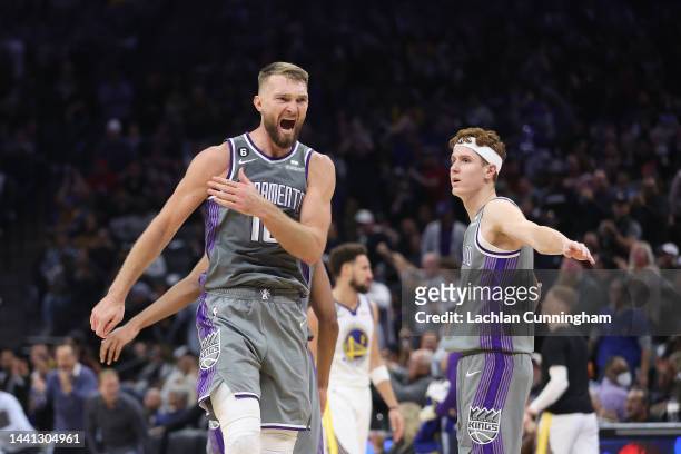 Domantas Sabonis of the Sacramento Kings celebrates with Kevin Huerter after a basket in the fourth quarter against the Golden State Warriors at...
