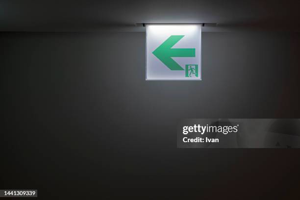 close-up of green emergency exit light sign - 非常口 ストックフォトと画像