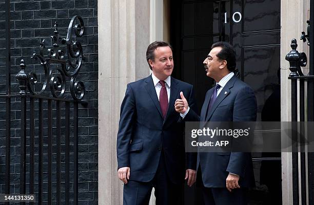 British Prime Minister David Cameron and Pakistan's Prime Minister Yousuf Raza Gilani pose for pictures after a meeting at 10 Downing Street, London,...