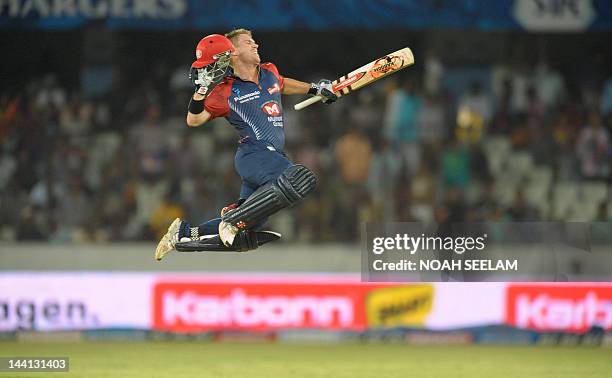 Delhi Daredevils batsman David Warner leaps in to air after scorong a century, 100 runs, during the IPL Twenty20 cricket match between the Deccan...