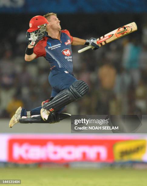 Delhi Daredevils batsman David Warner leaps in to air after scorong a century, 100 runs, during the IPL Twenty20 cricket match between the Deccan...