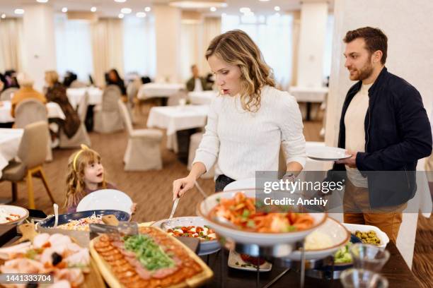 family enjoying breakfast buffet together in the hotel - salad bar stock pictures, royalty-free photos & images