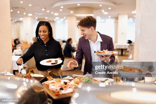 business people choosing breakfast at restaurant buffet - banquet stock pictures, royalty-free photos & images