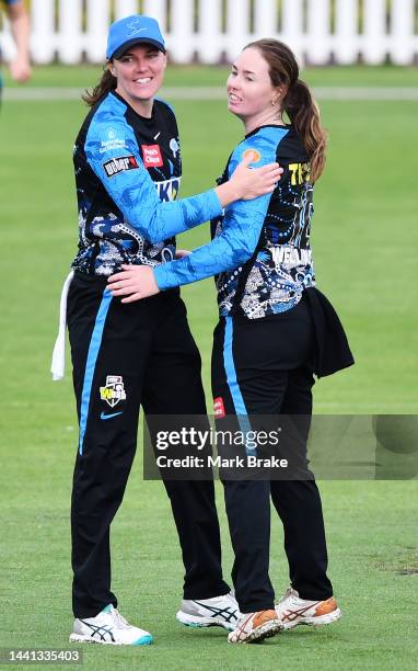 Amanda-Jade Wellington of the Adelaide Strikers celebrates the wicket of Grace Harris of the Brisbane Heat with Tahlia McGrath of the Adelaide...