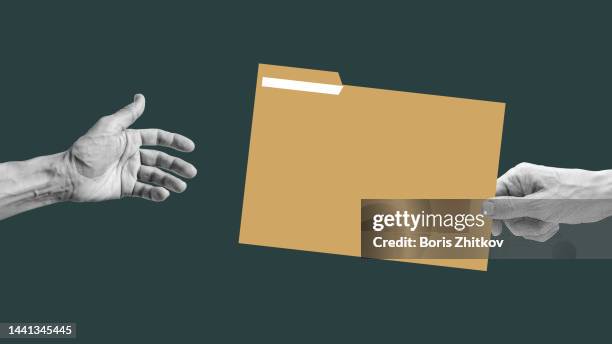 human hand passing the folder - bribery stock pictures, royalty-free photos & images