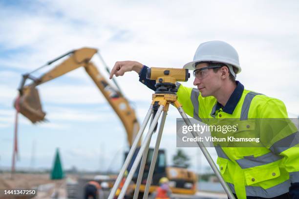 male engineer and survey equipment check elevation for construction work - theodolite stock pictures, royalty-free photos & images