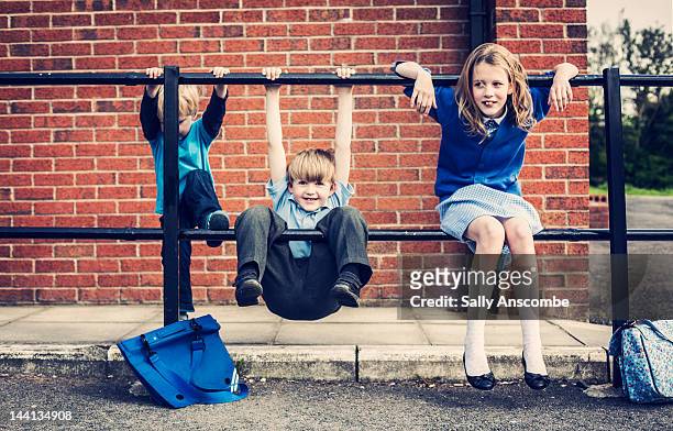 children waiting outside school - school uniform stock pictures, royalty-free photos & images
