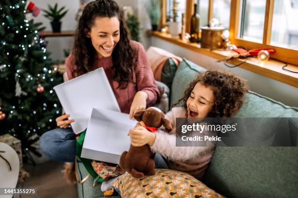 opening christmas present - child giving gift stock pictures, royalty-free photos & images
