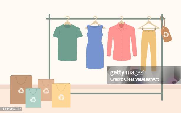 stockillustraties, clipart, cartoons en iconen met sustainable fashion store with recycled clothes hanging on rack. sustainable fashion and environmental protection concept - kledinghanger