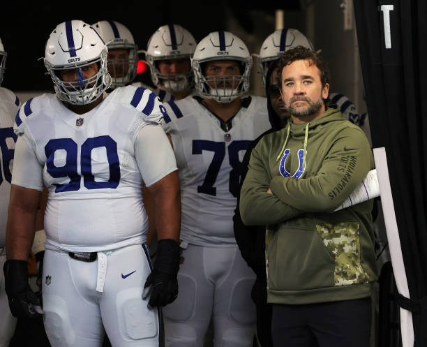 Defensive tackle Grover Stewart, center Ryan Kelly and interim head coach Jeff Saturday of the Indianapolis Colts wait to take the field before...