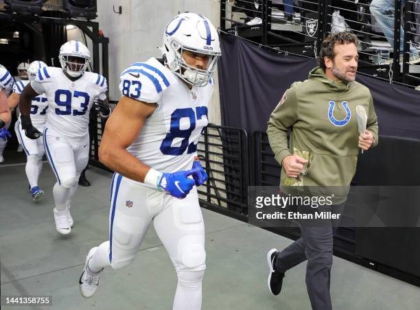 Defensive tackle Eric Johnson, tight end Kylen Granson and interim head coach Jeff Saturday of the Indianapolis Colts take the field for Saturday's...