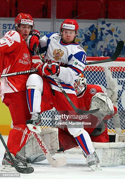 Jesper Jensen of Denmark battles for position with Denis Kokarev of Russia in front of the net during the IIHF World Championship group S match...