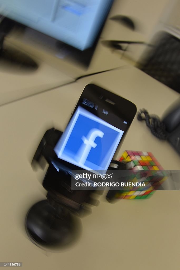 A mobile phone showing a Facebook page, 