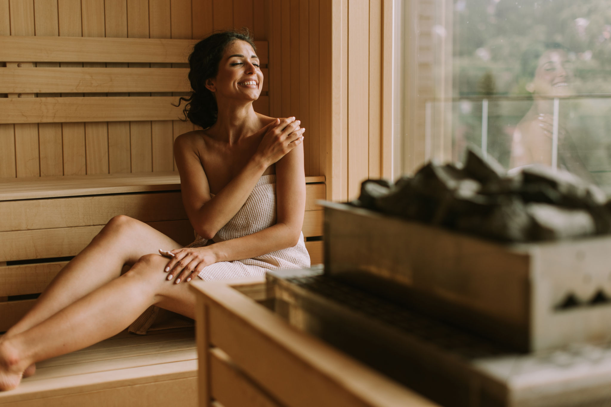 Young woman relaxing in the sauna Young woman relaxing in the sauna