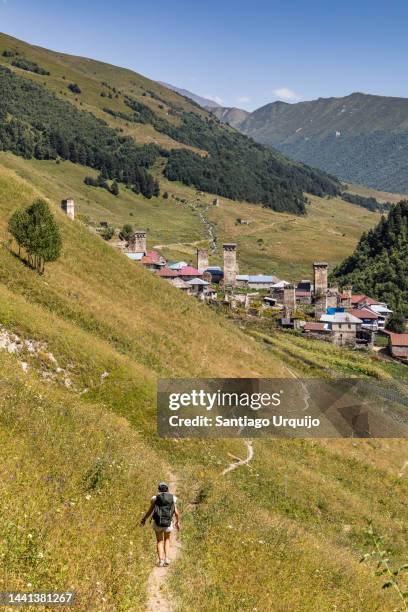 woman hiking towards the village of adishi - georgia country stock pictures, royalty-free photos & images