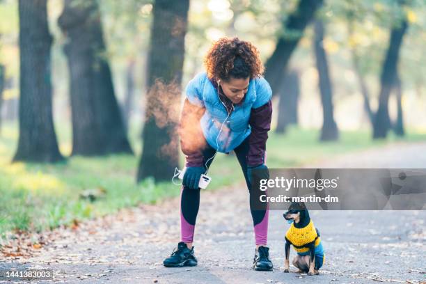 sportswoman taking a breath after jogging - black glove stock pictures, royalty-free photos & images