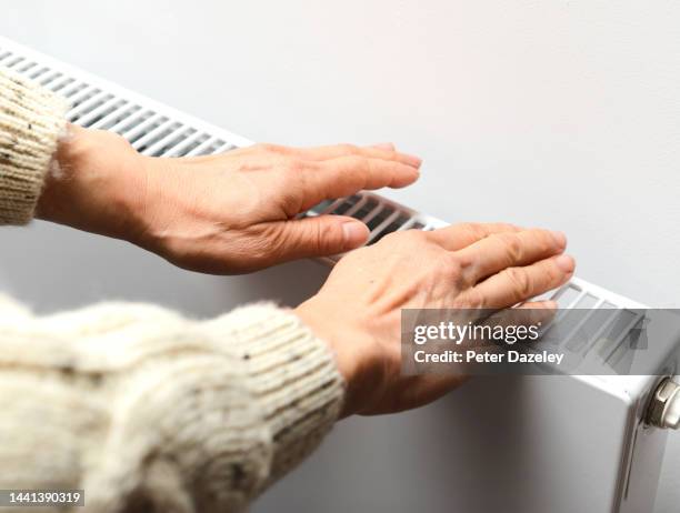 woman keeping hands warm - heat stock pictures, royalty-free photos & images