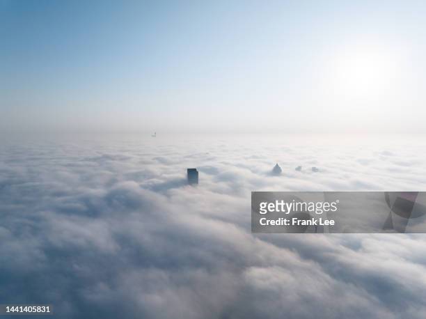 view of suzhou city over the advection fog at sunrise - skyscraper clouds stock pictures, royalty-free photos & images