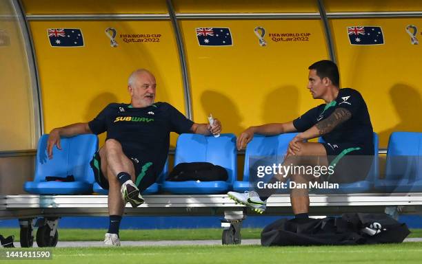 Graham Arnold, Head Coach of Australia talks with former player Tim Cahill during a training session at AspireZoneTraining Facilities on November 14,...