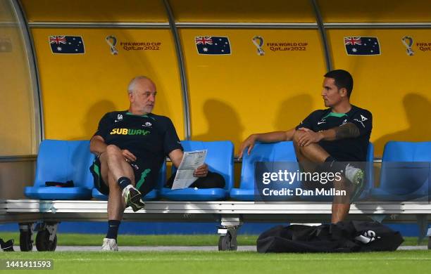 Graham Arnold, Head Coach of Australia talks with former player Tim Cahill during a training session at AspireZoneTraining Facilities on November 14,...