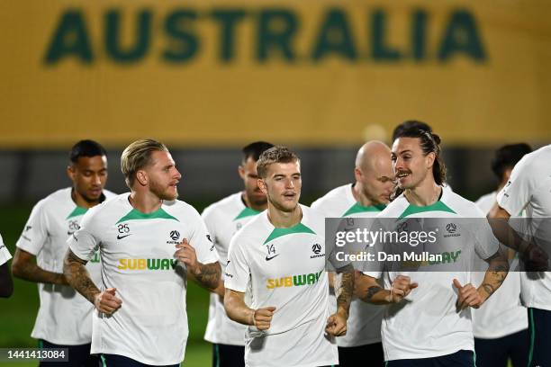 Jason Cummings, Riley McGree and Jackson Irvine of Australia warm up during a training session at AspireZoneTraining Facilities on November 14, 2022...