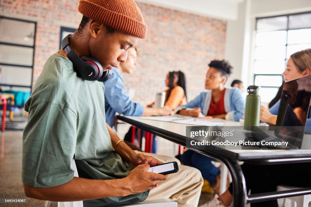Student Getting Text Message Concern Young Male Student Texting On His Phone During A Class High-Res Stock ...
