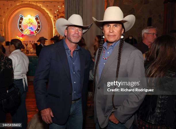 Taylor Sheridan and Mo Brings Plenty attend the premiere for Paramount Network's "Yellowstone" Season 5 at Hotel Drover on November 13, 2022 in Fort...