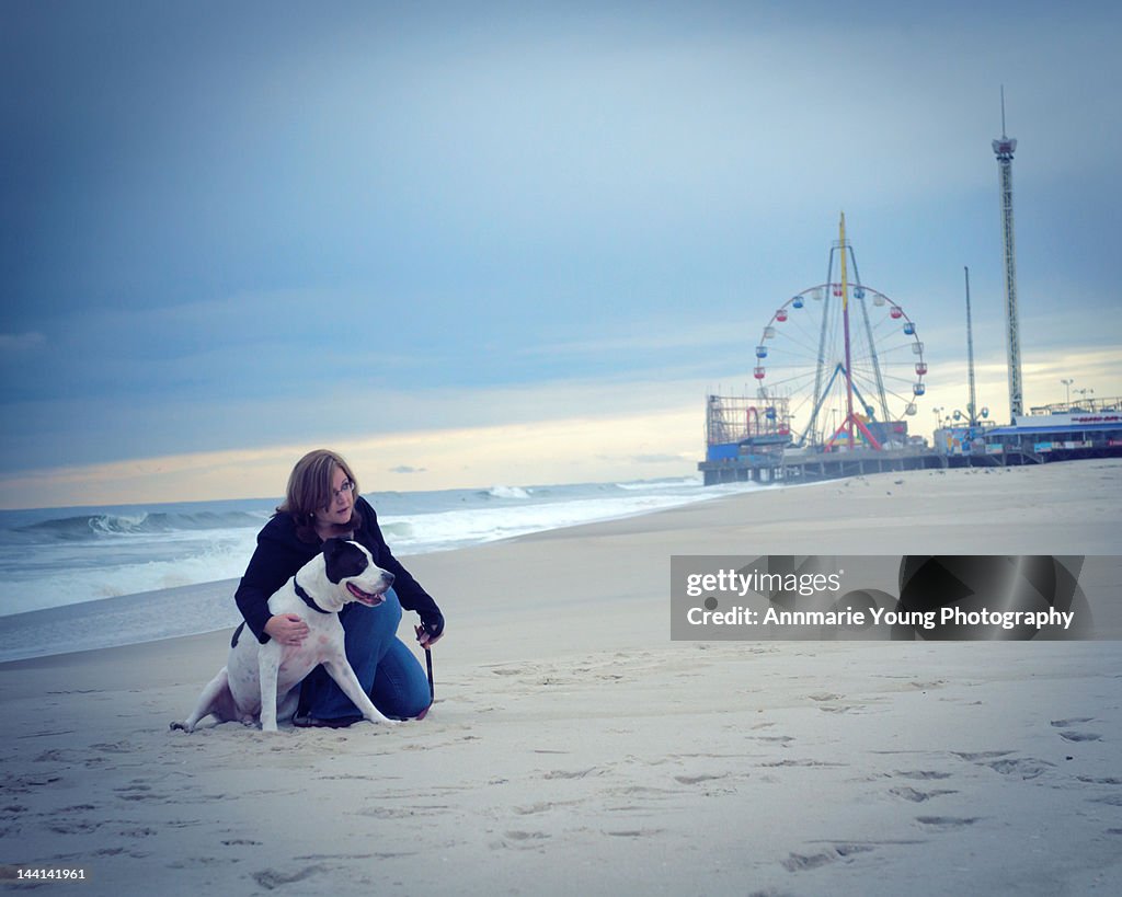 Dog and woman at seaside heights