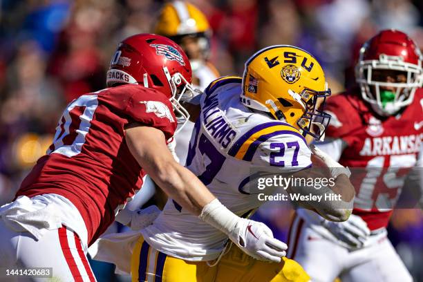 Josh Williams of the LSU Tigers runs the ball and is tackled by Bumper Pool of the Arkansas Razorbacks at Donald W. Reynolds Razorback Stadium on...