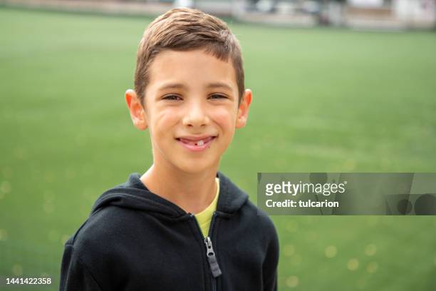 portrait of little boy in front of stadium - hoodie boy stock pictures, royalty-free photos & images