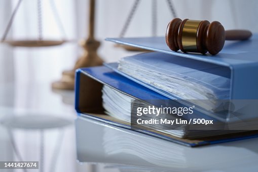 Gavel hammer on stack of document libra scale as background,Malaysia