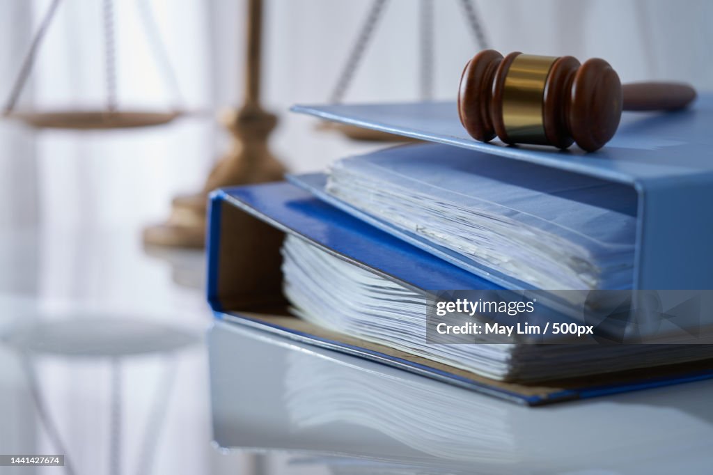 Gavel hammer on stack of document libra scale as background,Malaysia