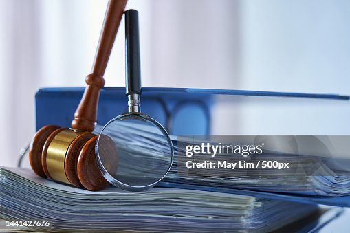 Magnifying glass gavel hammer on stack of document,Malaysia