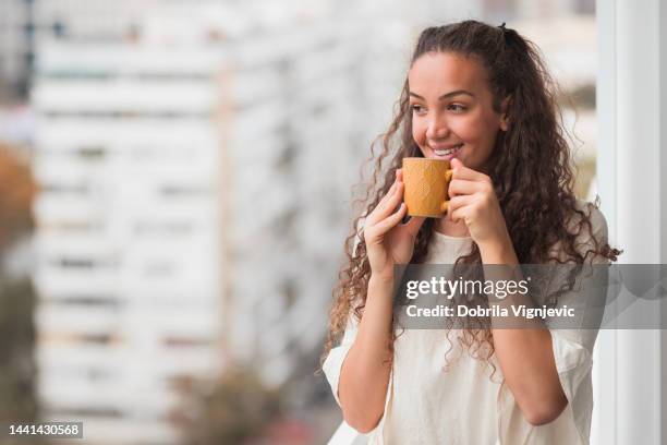 business woman drinking coffee an smiling, close-up - woman drink tea close up stock pictures, royalty-free photos & images
