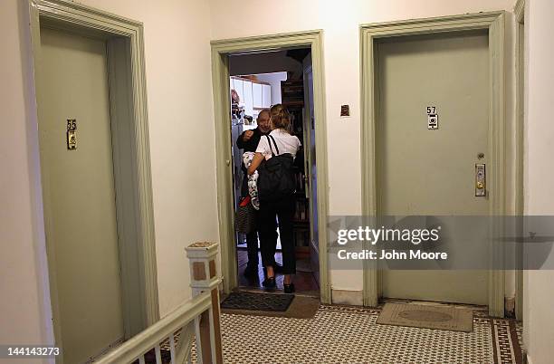 Pet owner Cris Cristofaro embraces veterinarian Wendy McCulloch as she arrives to his apartment to euthanize his sick dog Dino, age 12, on May 9,...