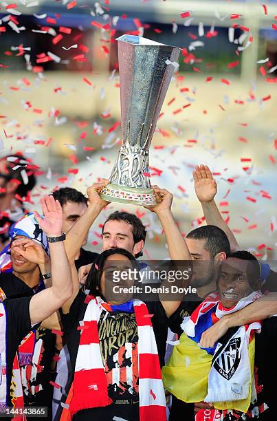 Radamel Falcao of Atletico Madrid holds up the Europa League trophy while celebrating with fans fans at Plaza Neptuno during a day after Atletico won...